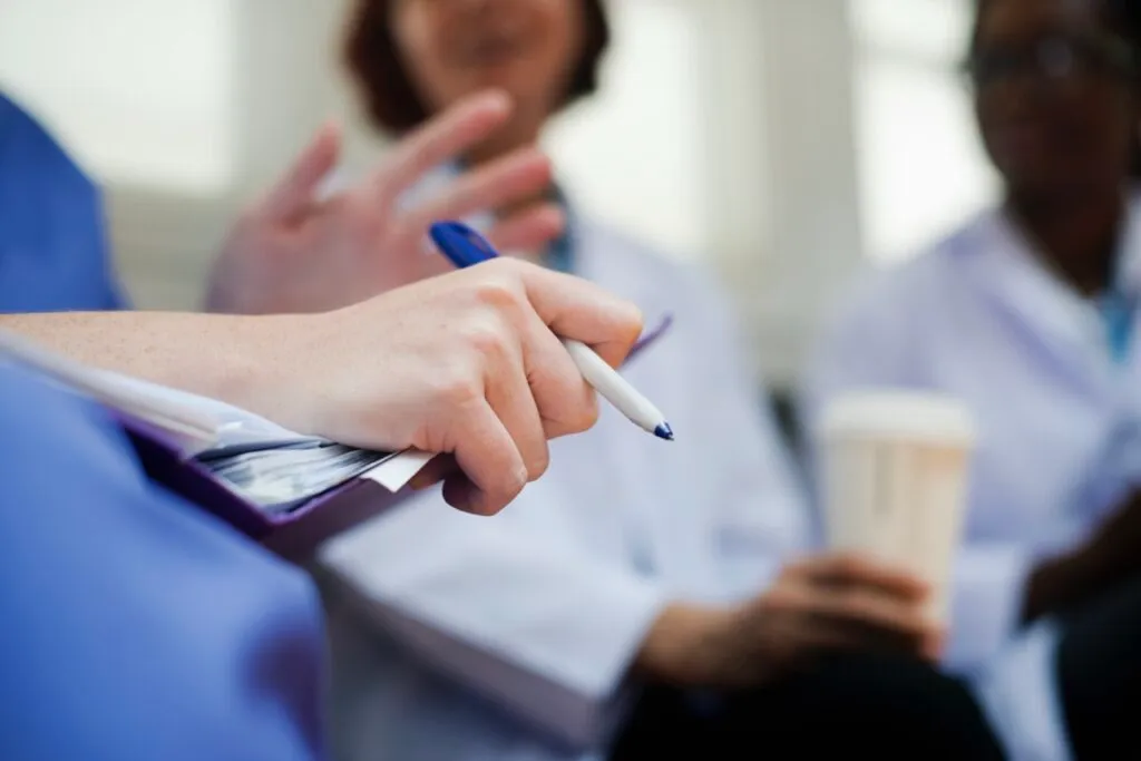 Practitioners taking notes during a session